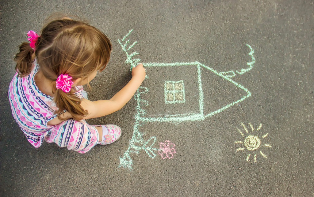young girl making doodle art in street floor
