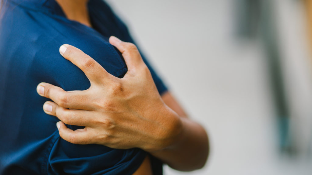 young woman with pain in shoulder,